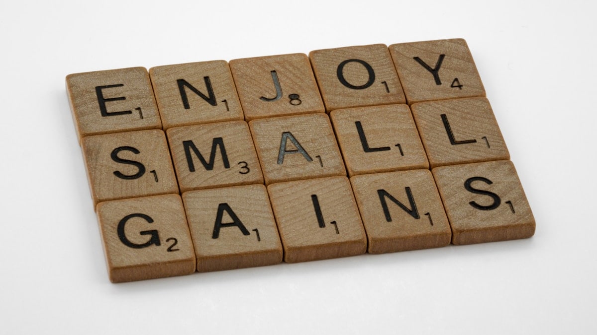 scrabble, scrabble pieces, lettering, letters, wood, scrabble tiles, white background, words, quote, letters, type, typography, design, layout, focus, bokeh, blur, photography, images, image, enjoy small gains, one step at a time, one day a time, incremental gains, measure, progress, steady progress, relentless, training, fitness, weight training, strength training, ageing, never give up, life, love life, optimism, mindfulness, reality, life coach, emotional health,